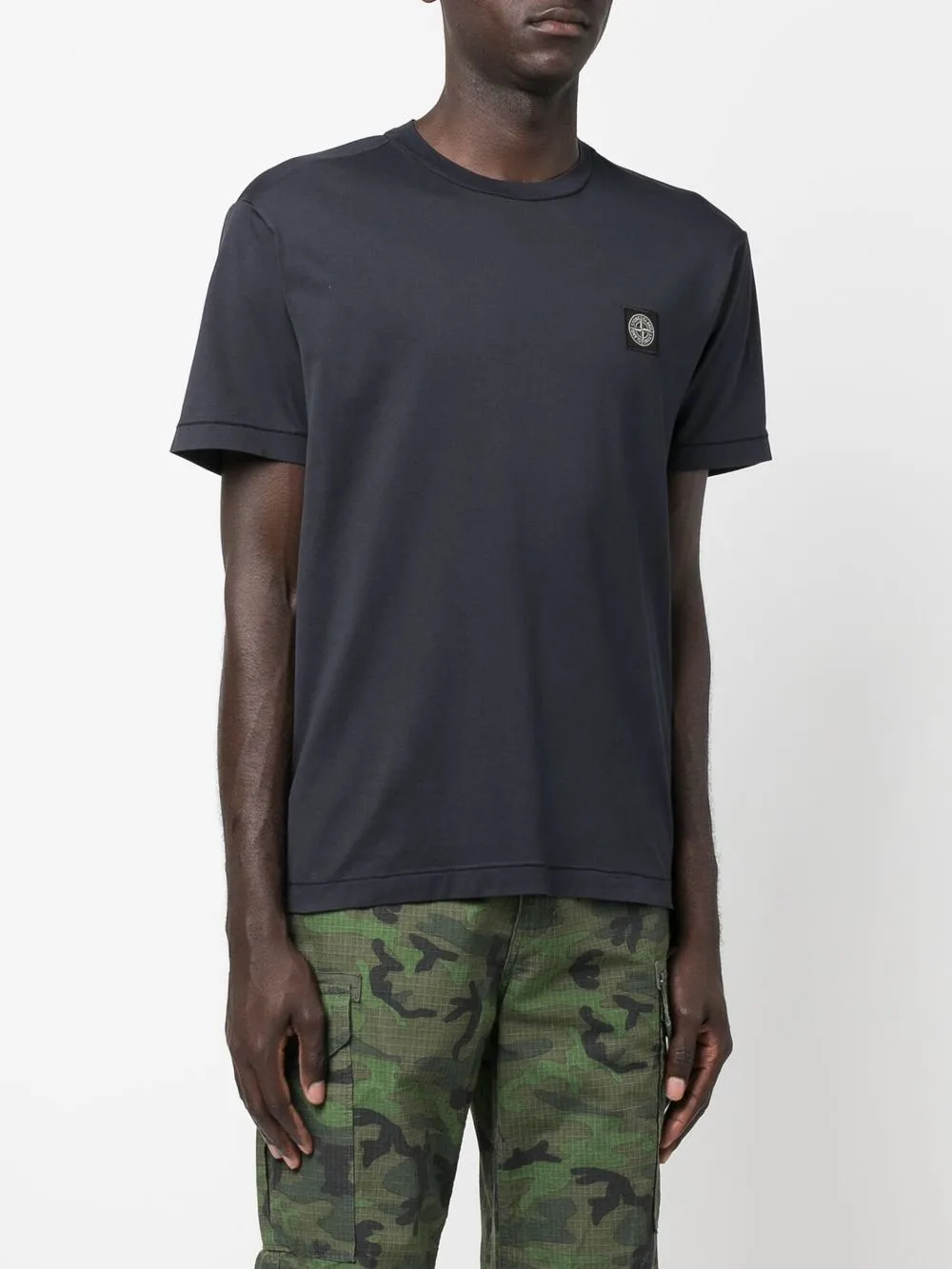 Stone Island blue T-shirt with compass logo patch.