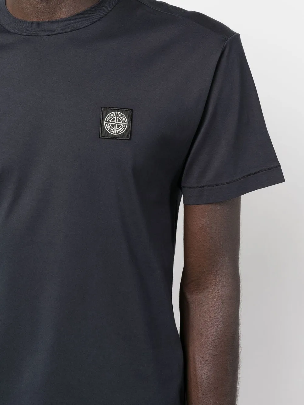 Stone Island blue T-shirt with compass logo patch.